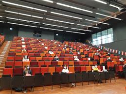 Welcoming exchange students in times of pandemic: In the big red Auditorium at HSD with About 400 seats 22 incoming students are placed according Corona distance regulations far from one another.